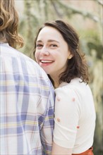 Young smiling woman next to boyfriend