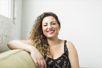Woman laughing with closed eyes