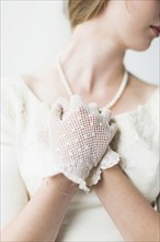 Mid section of bride wearing formal glove