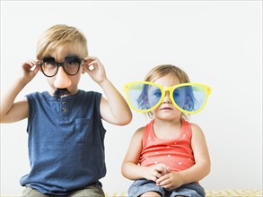 Children (2-3) wearing novelty glasses