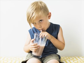 Young boy (2-3) drinking milkshake