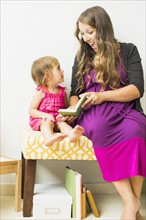 Mother reading to little daughter (2-3)