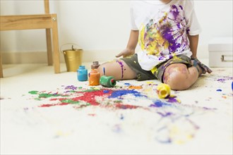 Boy (2-3) painting on carpet