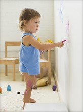 Girl (2-3) painting on wall