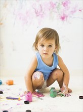 Little girl (2-3) painting on carpet
