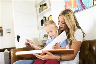 Mother reading book to son (4-5)