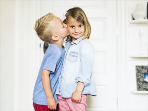 Little boy (4-5) kissing sister (4-5)