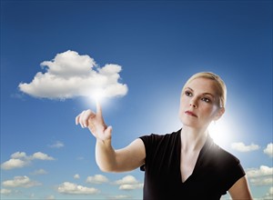Portrait of woman touching cloud.