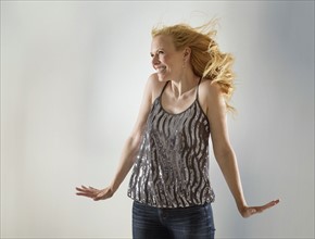 Happy woman dancing in studio.