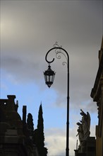 Argentina, Buenos Aires, Recoleta Cemetery, Sculpture and antique street light