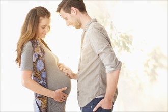 Pregnant woman holding hands with her boyfriend.