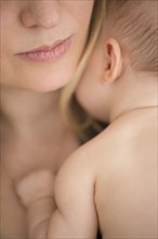 Mother consoling baby girl (2-5 months)