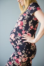 Studio shot of pregnant woman in floral dress