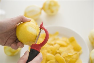 Personal point of view of person peeling lemons