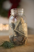 Jar with dollar bills and coins