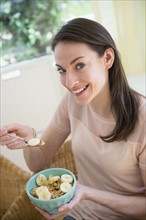 Woman at home eating healthy breakfast