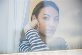 woman looking through window