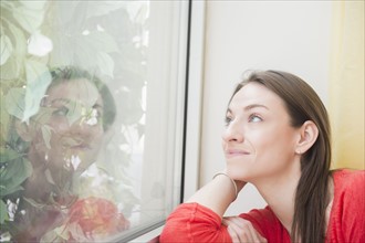 Smiling woman looking through window