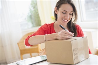 Woman addressing parcel