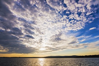 Cloudy sky above bay at sunset