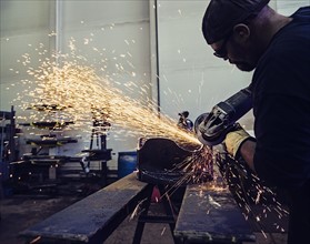 Welder working in metal workshop
