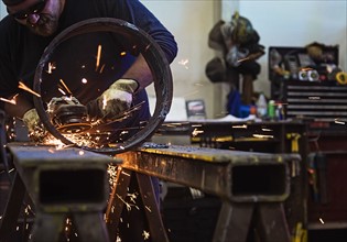 Welder working in metal workshop