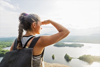 Rear view of young woman looking at view of lake