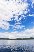 Lake under blue sky with clouds