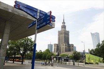 Sign post with Palace of Culture and Science in background