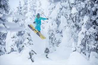 Skier jumping in forest