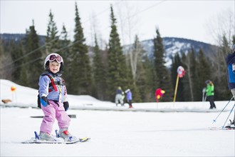 Little girl (2-3) learning skiing