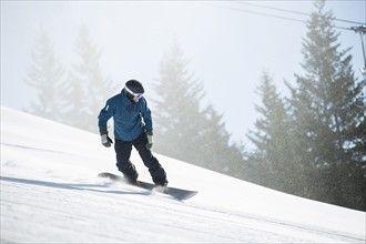 Man snowboarding downhill