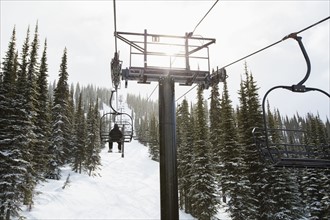 Man in ski lift, rear view