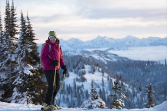 Female skier against mountains