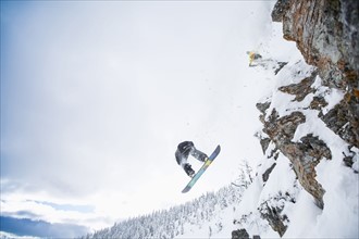 Low angle view of two men jumping from ski slope