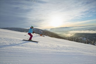 Couple skiing at sunset