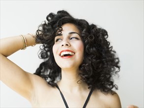 Portrait of smiling woman with dark curly hair