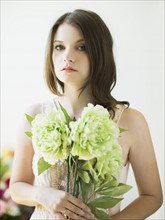 Portrait of woman holding flowers