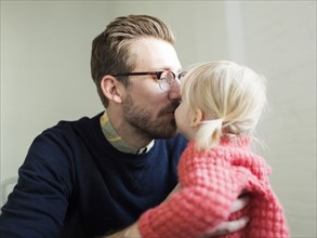 Father kissing daughter's (2-3) nose