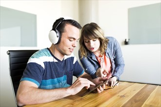 Man showing woman his music on smart phone