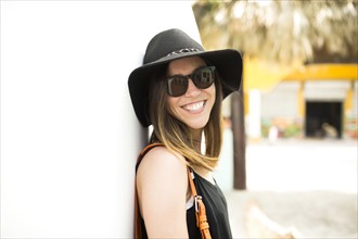 Portrait of woman wearing hat and sunglasses