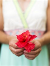 Woman holding tropical flower