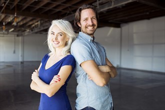 Woman and man standing in warehouse