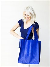 Studio shot of woman holding bag