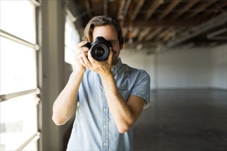 Portrait of man with digital camera