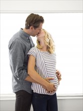 Husband kissing pregnant wife