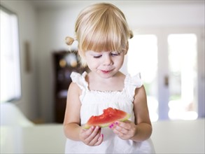 Portrait of girl (2-3) eating watermelon