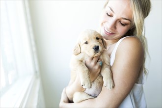 Woman holding Golden Retriever puppy