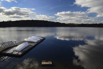Cloud reflection over boat dock Jamaica Pond