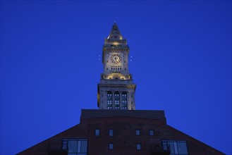 Illuminated clock tower at dawn